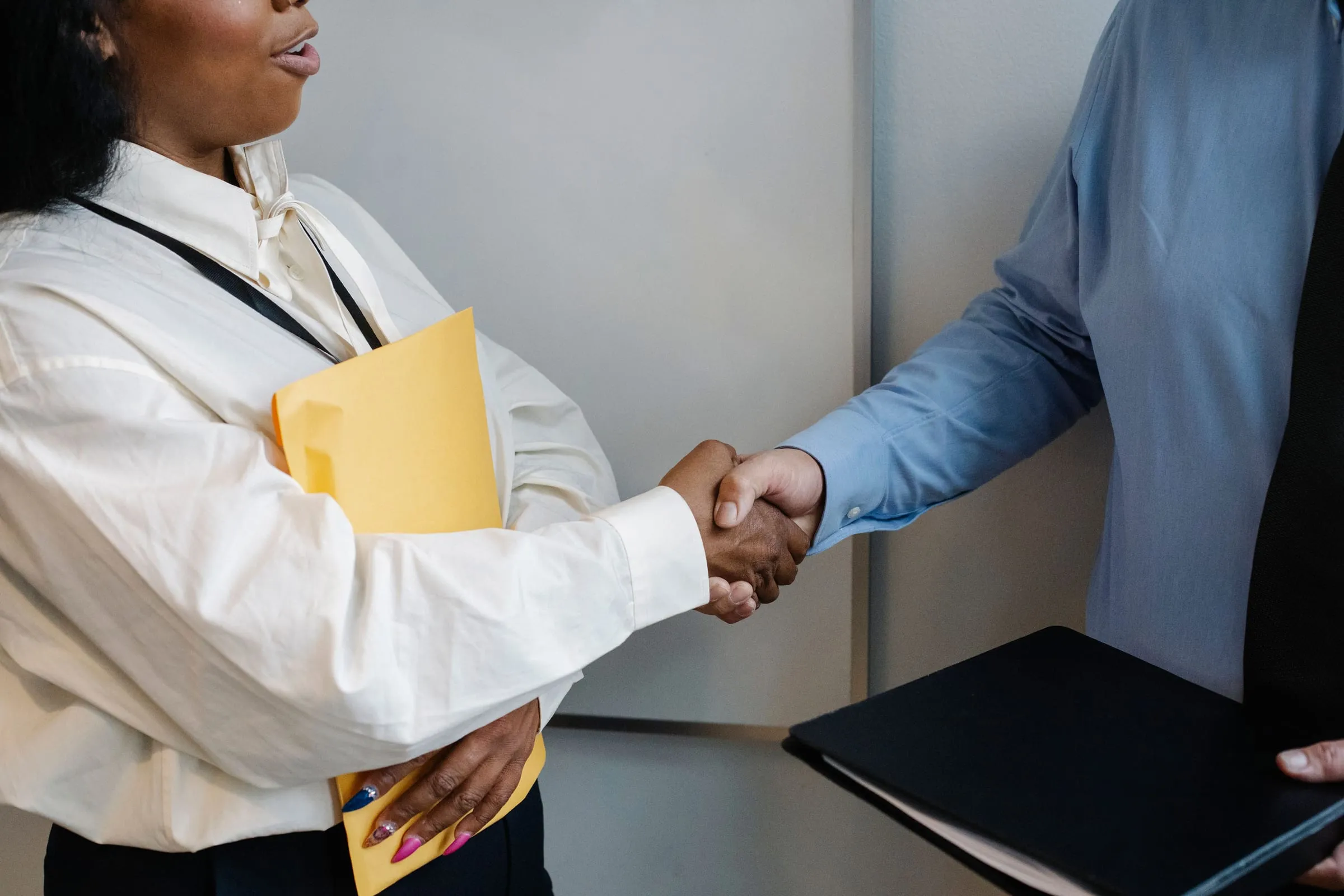 Two colleagues shaking hands after a meeting
